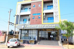 a white car parked in front of a building at Radiant Sky Hotel in Kuchāman City