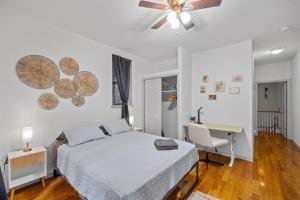 a bedroom with a bed and a desk and a ceiling fan at Private Room at a Shared Apartment by Times Square Manhattan in New York