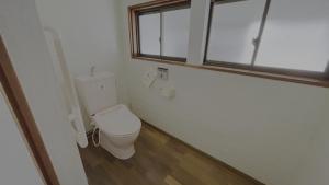 a bathroom with a toilet and a window at 萩市の静かな港町の一棟貸切宿 泊まれるカフェ 龍さん家 -Japanese traditional house- in Hagi