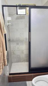 a shower with a glass door in a bathroom at Villa Mariaclaudia completa in Macas +31 photos