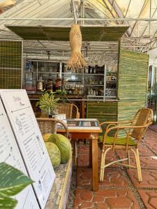 a restaurant with a table and chairs and a counter at Deep Forest Garden Hotel in Puerto Princesa City
