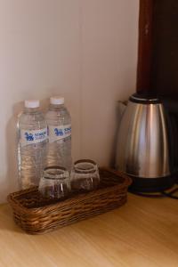 a basket with three bottles of water on a table at Mae Buya Coffee Farm Stay in Ban Huai Pong Nam Ron