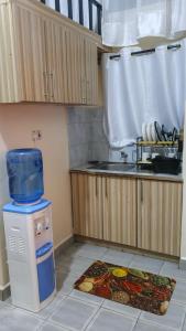 a kitchen with a sink and a counter with a stove at Modern studio apartment juja in Nairobi