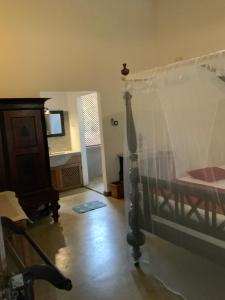 a bedroom with a bed with a canopy at Lali Villa in Galle