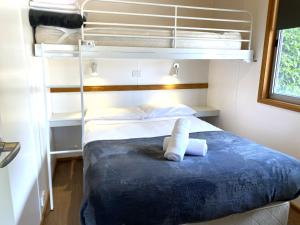 a bedroom with a bunk bed with towels on it at Geelong Holiday Park in Geelong +33 photos