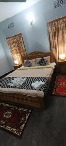 Postel nebo postele na pokoji v ubytování Noor Aman Guest House + 4 fotografie