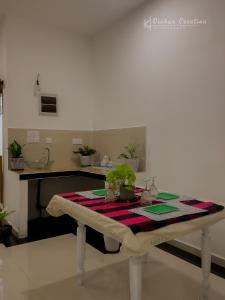 a table with a table cloth on it in a kitchen at Villa 592A - Hikkaduwa in Hikkaduwa +15 photos