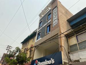 a building with a sign on the side of it at Hotel O Riwaz Inn in Gwalior