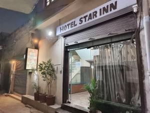 a hotel star inn sign on the side of a building at Hotel O Star INN in Jalandhar