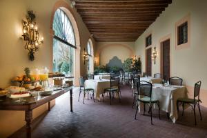 a dining room with tables and chairs in a building at Villa Michelangelo Vicenza – Starhotels Collezione in Arcugnano +73 photos