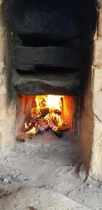 a brick oven with fire inside of it at Red Clay Pension Dream Conversation in Donghae