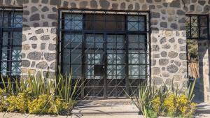 a window in a stone building with plants in front of it at Casa Ñogi  +4 photos
