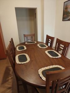 a wooden dining room table with chairs at Watawala Tea Garden in Rozella