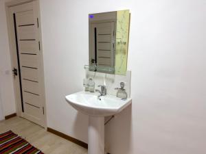 a bathroom with a sink and a mirror at Nur Homestay in Nurata Mountains in Yukary-Ukhum