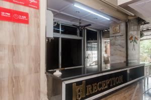 a restaurant with a sign on the side of a building at Hotel O Shalimar in Mumbai