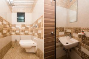 a bathroom with a toilet and a sink at Hotel O Shalimar in Mumbai