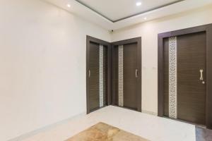 a walk in closet with a row of glass doors at Hotel O Shree Vishwanath in Varanasi
