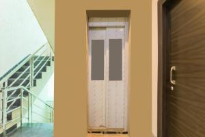 an open door in a house with a staircase at Hotel O Shree Vishwanath in Varanasi +21 photos