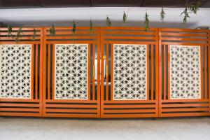 an orange door with three windows in a room at Hotel O Shree Vishwanath in Varanasi