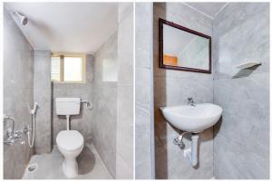 a bathroom with a white toilet and a sink at Super Hotel O Guntur Railway Junction in Guntūr