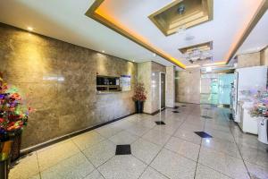 a lobby of a building with flowers on the wall at Yeosu Apple Hotel in Musŏn