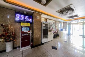 a lobby with a ticket machine in a building at Yeosu Apple Hotel in Musŏn