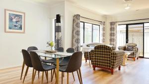 a dining room with a table and chairs at Highlands 3B House by GoodLive in Craigieburn
