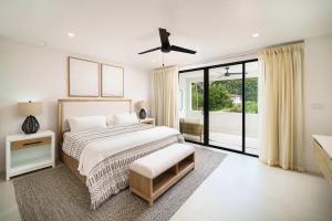 a bedroom with a bed and a large window at Walk to Beach New Stylish 3BR Pool in Saint James