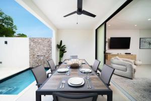 a dining room with a table and a swimming pool at Walk to Beach New Stylish 3BR Pool in Saint James