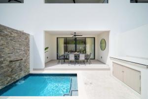a kitchen and dining room with a swimming pool in a house at Walk to Beach New Stylish 3BR Pool in Saint James +10 photos