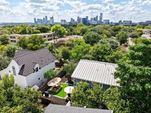 an aerial view of a house with a city in the background at Central East Austin Luxury Hot Tub & Game Room in Austin