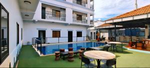 a balcony with a table and chairs next to a building at Angkor Sunshine Oasis in Siem Reap