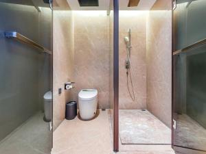 a bathroom with a shower and a toilet at Mousse Hotel Liyang Railway Station Museum Branch  +26 photos