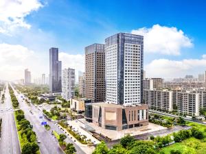an aerial view of a city with tall buildings at Mousse Hotel Liyang Railway Station Museum Branch 