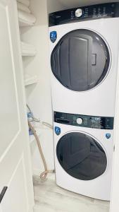 a microwave oven sitting next to a washing machine at Ivey Homes in Edmonton