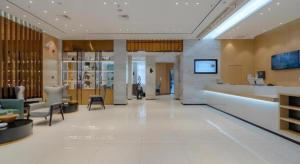 a lobby of a hospital with chairs and a counter at City Comfort Inn Hefei 1912 Ganghui Plaza in Hefei