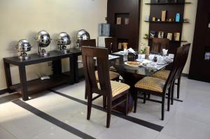 a dining room with a table and chairs with helmets on them at Gofas Lodge in Islamabad