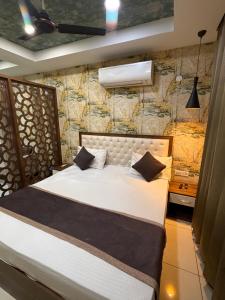 a bedroom with a bed and a stone wall at The Cove in Zirakpur