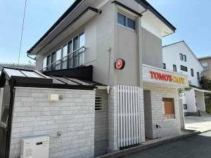 a white building with a red sign on it at TC1 Nagano - Vacation STAY 10022v in Okaya