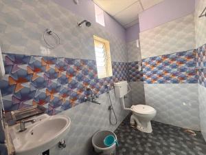 a bathroom with a sink and a toilet at Collection O Arya Vidyapeeth College Guwahati in Guwahati