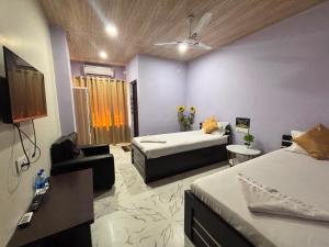 a room with a bed and a couch in a room at Collection O Arya Vidyapeeth College Guwahati in Guwahati