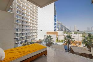 a bedroom with a yellow bed in a building at FIVE Palm Residence - Elegant Homes in Dubai