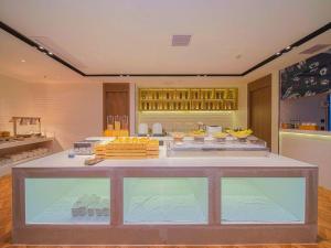 a room with a counter with food on it at Echarm Hotel Foshan West Station Shishan Luocun in Luocun