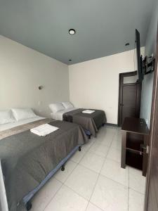 Postel nebo postele na pokoji v ubytování Hotel Orquídea