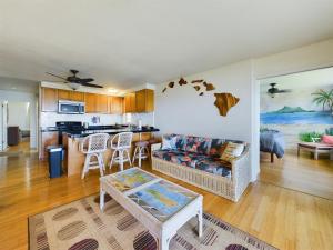 a living room with a couch and a table at Oceanfront true 2 bedroom wlanai on Molokai in Ualapue