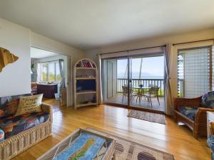 a living room with a couch and a table at Oceanfront true 2 bedroom wlanai on Molokai in Ualapue