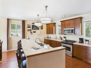 a kitchen with a sink and a stove top oven at Family Getaway in Juneau, Alaska Unforgettable Ocean and Mountain Views in Mendenhaven