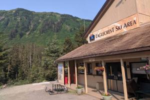 a building with a sign that reads abject ski area at Douglas Island A-frame Cabin in the woods in Juneau International Airport