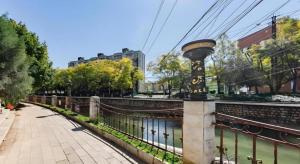 a bridge over a river with a light on a pole at GELI Kunming North Railway Station Zoo in Kunming
