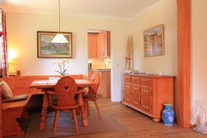 a kitchen with a table and chairs and a dining room at Villa Montelago in Rottach-Egern